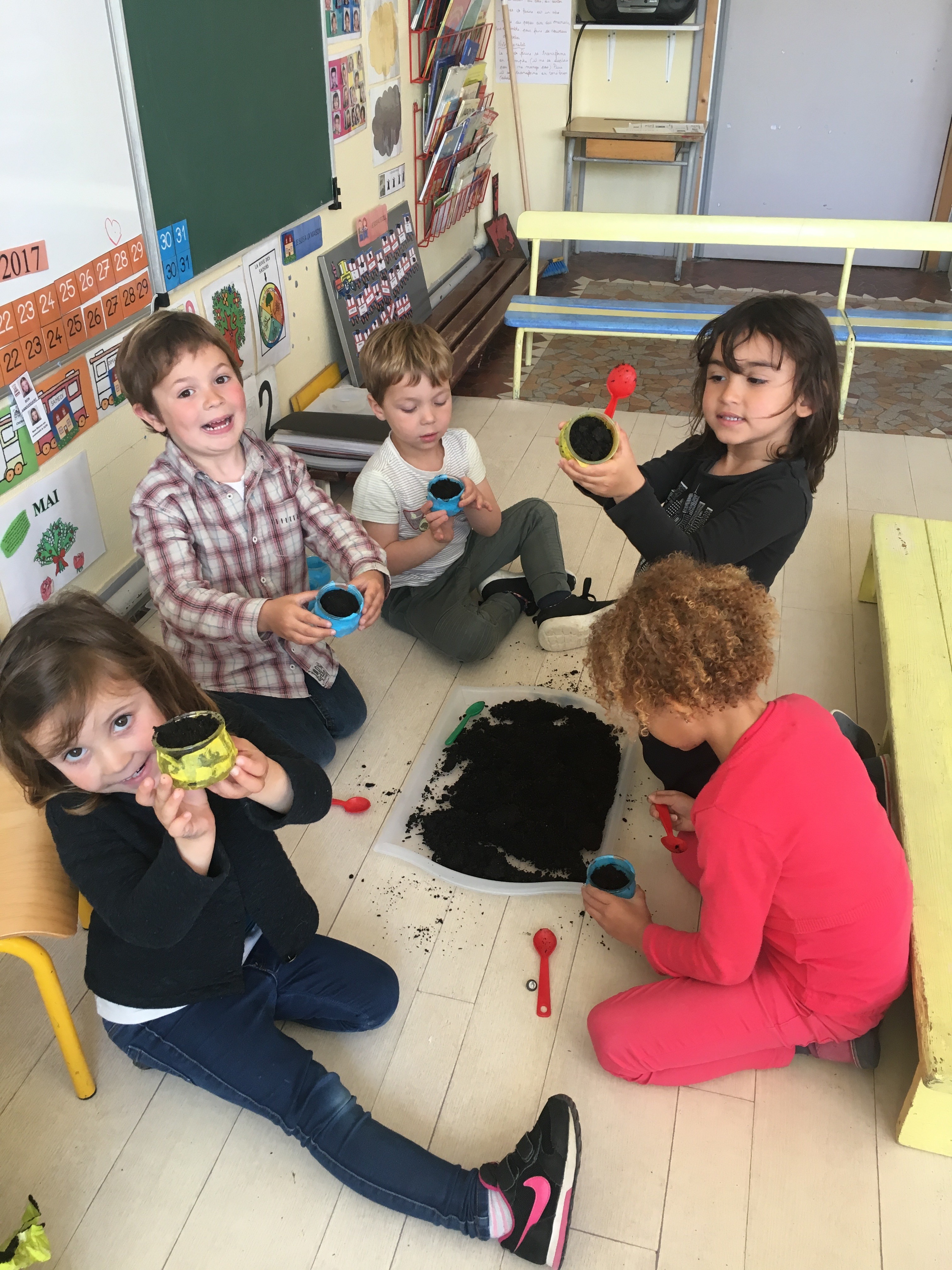 Nous avons, d’abord décoré nos petits pots en verre avec du papier de soie. Une  fois le papier sec, nous avons rempli les pots avec de la terre puis mis les graines, un peu partout, pour enfin les recouvrir avec un peu de terre. Sans oublier d’arroser !